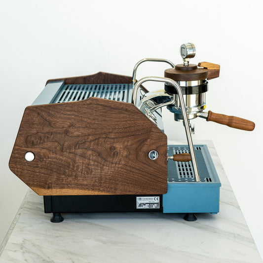 Modern blue espresso machine on a white counter