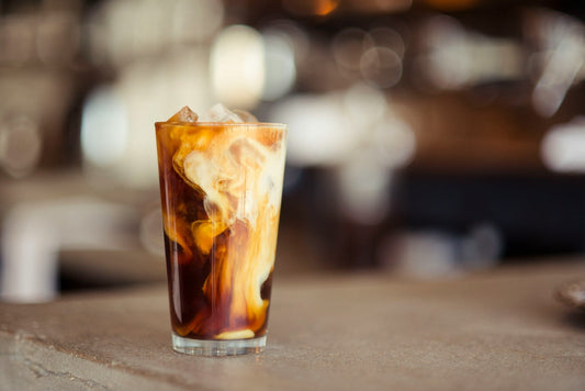 An iced vanilla latte on a coffee shop counter